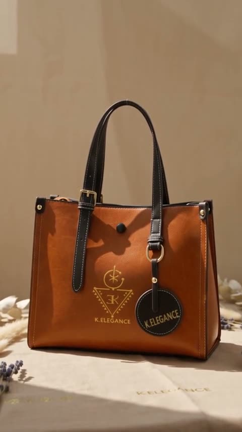 A tan leather tote with a gold K.Elegance mark, shown close at the strap and buckle, carried down a cobbled street, and set on a bench.